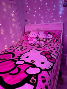 a bedroom with hello kitty bedding and pink lights