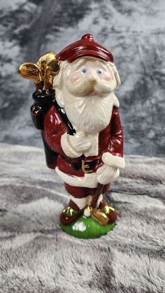 a santa clause figurine holding a trumpet