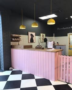 a checkered floor and pink counter in a restaurant