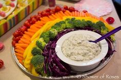 a platter filled with vegetables and dip