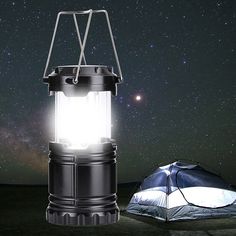 a light that is on top of a tent in the night sky with stars behind it