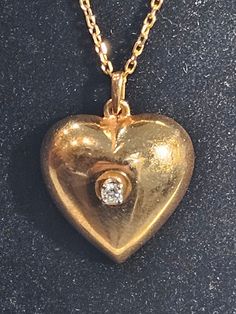 Heart  vintage 14K Gold chain and  heart pendant with  center diamond  Stone diamond 0.10 carats Chain signed 585 14K gold  Chain length 18 inches Total weight 8.7 gramms 14K  Shiny  amazing  One of a kind ! Vintage Diamond Necklace In Yellow Gold, Vintage Round Diamond Necklace Gift, Vintage Hallmarked Diamond Necklace, Antique Diamond Necklace With 17 Jewels For Anniversary, Victorian Diamond Necklaces For Anniversary, Vintage Yellow Gold Diamond Necklace, Antique Diamond Accents Necklace For Anniversary, Vintage Gold Diamond Necklaces, Victorian Diamond Necklace For Gift