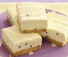 four pieces of cake sitting on top of a purple plate