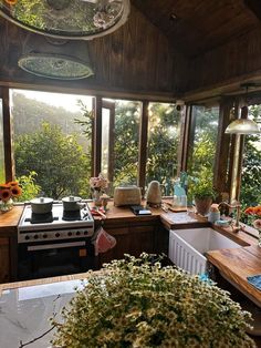 a kitchen filled with lots of counter space next to a stove top oven and sink