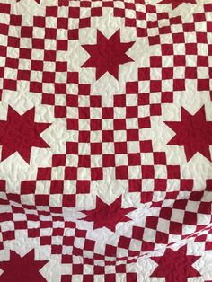 a red and white quilt with stars on it