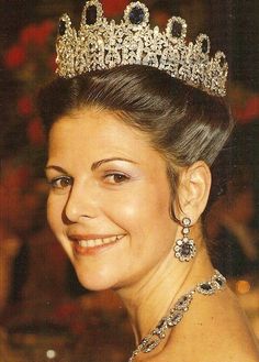 a woman wearing a tiara and smiling at the camera