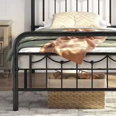 a bed with metal frame and foot board