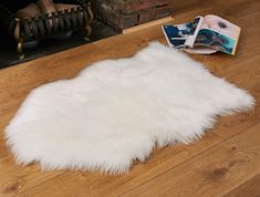 PRICES MAY VARY. LUXURY SHEEPSKIN RUG - With exquisite softness and a luxuriously dense pile -in a natural shape that looks perfect as an area rug, or draped on your favorite armchair. PREMIUM QUALITY - Our White Faux Fur Rug is thicker, fluffier and softer then others. Includes a suede backing with reinforced stitching. PERFECT SIZE - At 2x3 feet this white rug will easily fit anywhere. ANIMAL CRUELTY FREE - Here at O'ranch we firmly opposed to animal cruelty. Our white fluffy rug is made from White Area Rug Bedroom, Panda Kindergarten, White Fluffy Rug, White Faux Fur Rug, Dorm Gifts, Faux Fur Area Rug, Ranch House Decor, Diy Tumblr, Cool Dorm Rooms