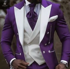 a man in a purple suit and white shirt