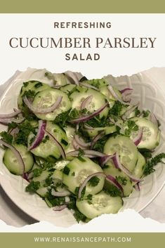 a white plate topped with cucumber parsley salad on top of a table