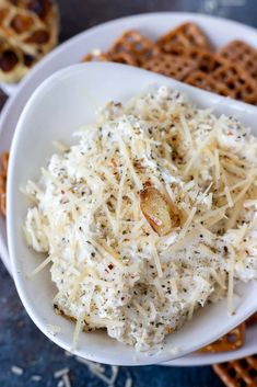 a white bowl filled with cheese and crackers