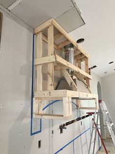 a room that has some wooden shelves on the wall and scaffolding around it