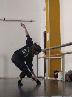 a young woman is practicing her moves on the dance floor