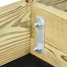 a close up of a door handle on a wooden frame with wood grain in the background