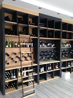 a wine cellar filled with lots of bottles and ladders to the top of it