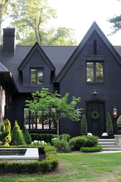 a black house with steps leading to the front door