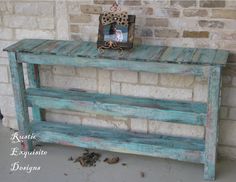 a wooden bench sitting next to a brick wall with a frame on top of it