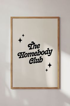 the homeboy club logo is displayed on a white wall above a wooden framed sign