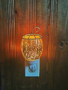 a light that is on the side of a wooden door with a string attached to it