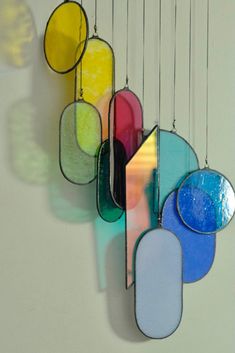 a multicolored glass wind chime hanging from a wall