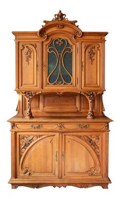 an old fashioned wooden cabinet with ornate carvings on the front and side panels, in light wood