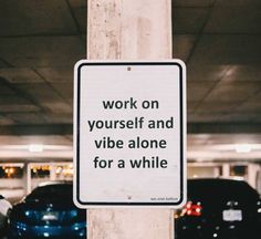 a sign on a pole that says work on yourself and vibe alone for a while