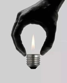 a light bulb being held by a hand