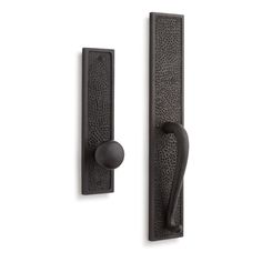 an iron door handle with a black finish on the front and back of it,