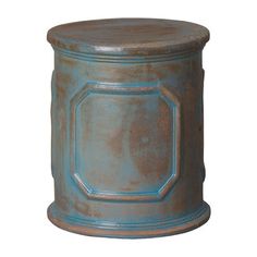 an old blue tin canister with a square design on the top and bottom, isolated against a white background