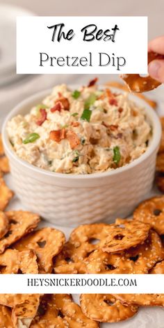 a bowl filled with chicken salad next to crackers on a white plate and the words pretzel dip above it