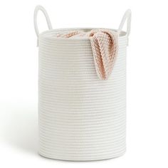 a white basket with a pink bow on the top and bottom, sitting against a white background