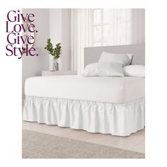 a white bed with ruffled bedspread and pillows