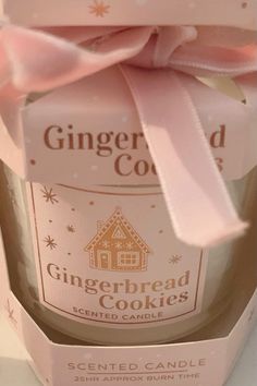 a gingerbread cookie in a pink gift box