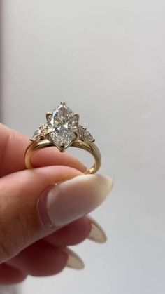 a person holding a diamond ring in their hand