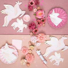 paper unicorns and flowers on a pink background