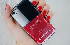 a woman's hand holding an iphone case with a red nail polish on it