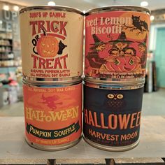 three halloween tins are stacked on top of each other