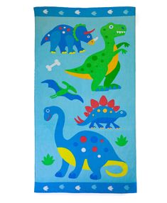 a blue towel with dinosaurs and bones on the front, one dinosaur is in the middle