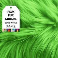 a green fur texture with a white tag hanging from it's center and the words faux