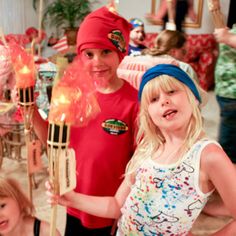 two young children are posing for the camera while holding firecrackers in their hands