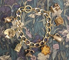 Beautiful thick (10x12mm) brass curb chain bracelet with 8  3D  brass charms. The charms are a mixture of new and vintage (unused) and include a handbag, rose, bird cage with hanging bird (new) and a frog on lilypad, coffee pot, telephone, kettle and carousel (vintage).  The bracelet is a lovely golden colour but as with all brass jewellery it will darken with time but can be repolished or left to form a natural patina as desired. The bracelet will be supplied in a velvet gift pouch. Affordable Vintage Gold Charm Bracelet, Luxury Retro Bracelet As Gift, Luxury Vintage Charm Collectible, Cheap Vintage Charm Brass Jewelry, Cheap Vintage Brass Jewelry With Charm, Affordable Vintage Charm Brass Jewelry, Cheap Vintage Charm Bracelet Gift, Luxury Antique Charm Bracelet, Cheap Vintage Charm Bracelet As Gift