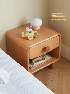 a small wooden table with a stuffed animal on it's shelf next to a bed