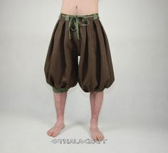 Pants made of brown and dark brown linen (100%). The pants are pleated at the waist and on the pant legs. In addition, each visible stitch is handmade with linen thread, the inner double stitches are machine-made. The shape is based on the Haithabu find, short legs below the knee.  Size XXL: waist circumference 114 cm / 44,88 (tolerance from 110 cm to 114 cm / 43.31 in to 44,88 in ), trouser length from waist to leg 75 cm / 29,53 in; from crotch to knee 43 cm / 16,93 in, leg width below knee 54 Viking Pants, Wizard Costume, Handmade Pants, Viking Clothing, Short Legs, Linen Clothes, Adult Costumes, Gorgeous Dresses, Dress Making