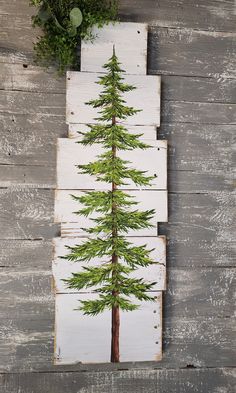 a pine tree is painted on wood planks