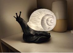 a snail lamp sitting on top of a table