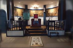 the interior of a church with two cribs and paintings on the wall behind them