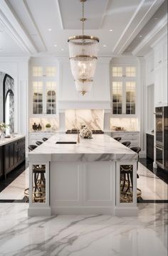 a large kitchen with marble counter tops and white cabinets, chandelier hanging from the ceiling