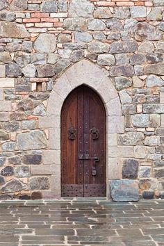 an old stone building with a wooden door