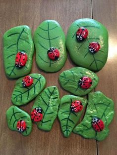 some green rocks with ladybugs painted on them