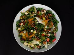 a white plate topped with salad and apples